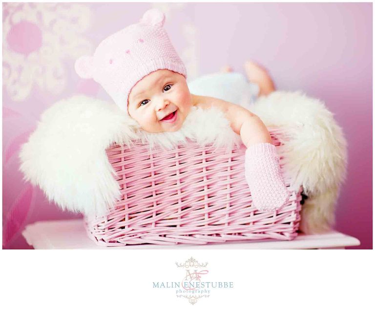 newborn baby girl in pink knitted bear hat